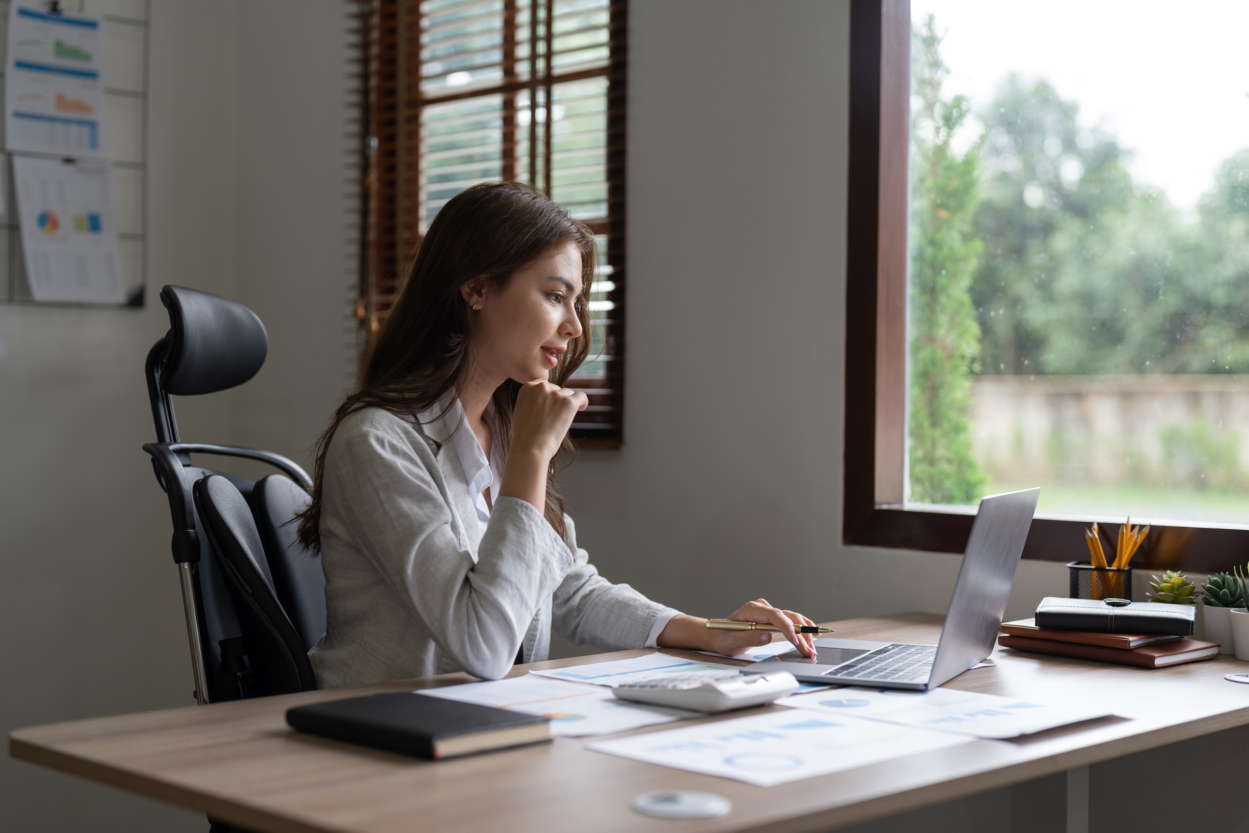 Insurance agent sits at desk calculating deductible and copay