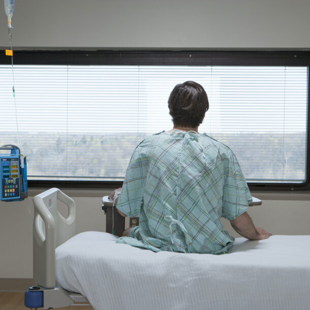 Patient sitting up in a hospital bed.