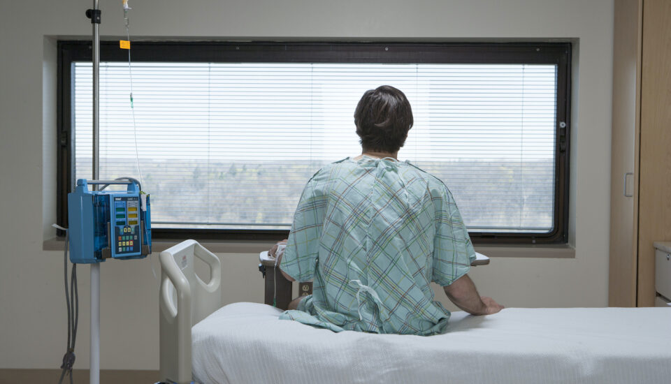 Patient sitting up in a hospital bed.