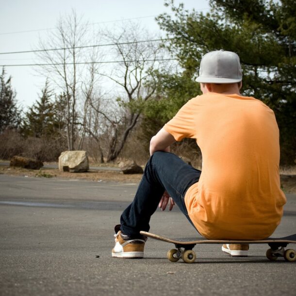 A young skater resting on his board.