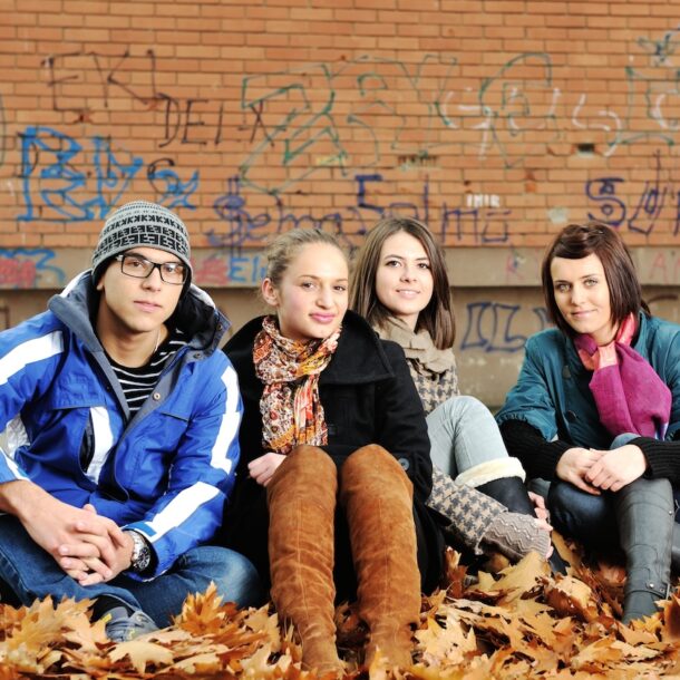 Group of adolescent teens together in a city.