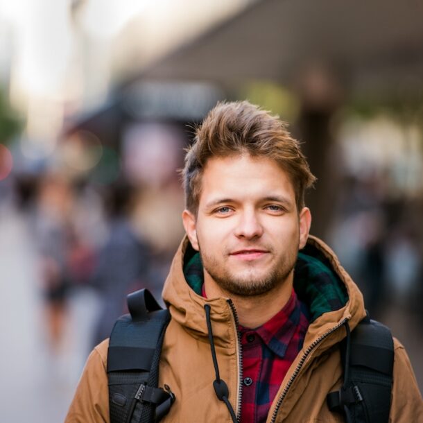 Young man walking down a city street.