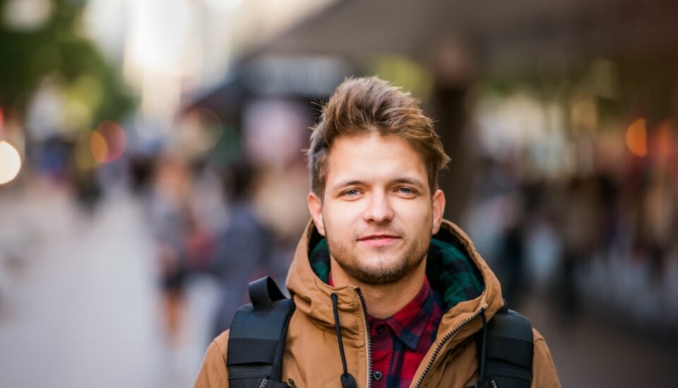 Young man walking down a city street.